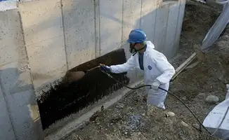 Professional waterproofing the exterior walls of the basement in Long Beach, CA