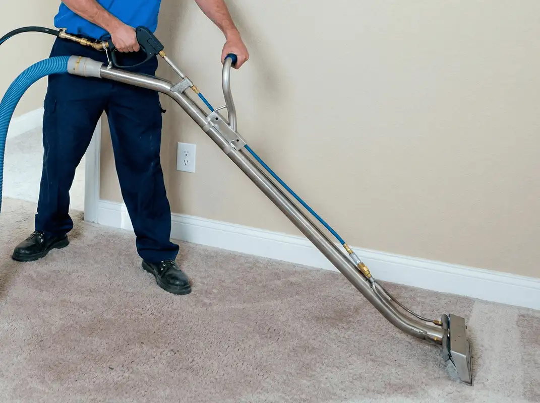 Professional operating a liquid removal machine on a carpeted floor in Long Beach, CA